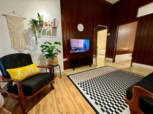 a living room with a couch and a tv at JAMBU MANIS STAY- Business Traveller Friendly, Family Comfort, Kuala Berang- Free Netflix,Wifi in Kuala Berang