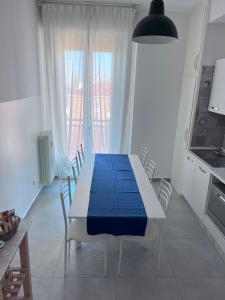 a dining room with a blue table and chairs at B&Bononia View in Bologna +43 photos