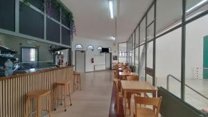a restaurant with tables and chairs and a counter at Albergue de peregrinos San Cipriano in Ayegui