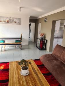 a living room with a couch and a table at 46 Charles Bed and Breakfast in Tierpoort