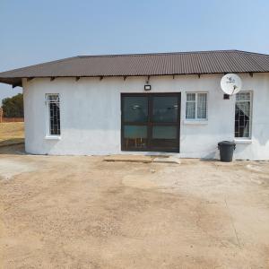 a white building with a large sliding glass door at 46 Charles Bed and Breakfast in Tierpoort +8 photos