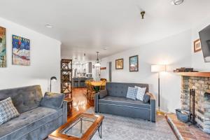 a living room with two couches and a fireplace at Ski Team 1 in Park City