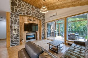a living room with a couch and a fireplace at Les Chalets Immersion in Saint-Raymond