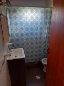 a bathroom with a sink and a toilet at somos "EL FIN DEL AFAN" 2, casa con vistas a las sierras in Potrero de los Funes