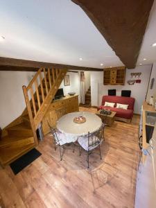 a living room with a table and a couch at Espace Diamant - Duplex typiquement Savoyard in Flumet