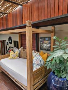 a wooden bunk bed with pillows and a potted plant at The Residence in Johannesburg +135 photos