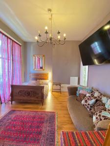 a living room with a bed and a couch at Balcony Flat next to Port, Sea view, Free Parking in Dover