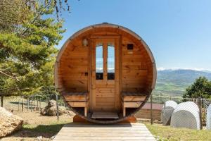 a small wooden observatory with a door in the middle at Cabane perchée avec sauna en pleine nature in Gap