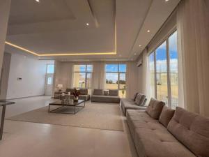 a large living room with a couch and a table at Jabal Akhdar Rummana Villa in Al ‘Aqar