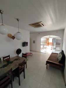 ein Wohnzimmer mit Tisch und Couch in der Unterkunft Casa de Temporada Preciosa in Novo Airão