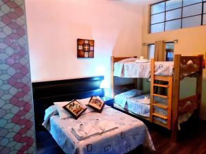 a room with two bunk beds and a mirror at Samay Misti Apartment in Arequipa +47 photos