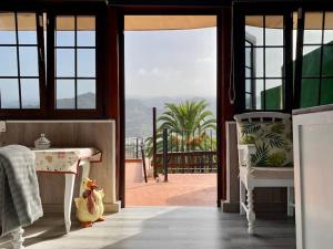 a room with a table and two chairs and a balcony at Casa Abuelitilla in Teror