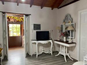a living room with a desk with a television on it at Casa Abuelitilla in Teror