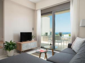 a living room with a couch and a television at Leya villa in Tavronitis