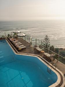 a swimming pool with a view of the ocean at Miraflores Park, A Belmond Hotel, Lima in Lima