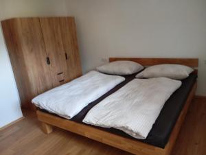 a bedroom with a bed with a wooden headboard at Ferienwohnung Maier in Mittersill