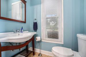 a bathroom with a white sink and a toilet at Steps from Journeyman in Downtown Valparaiso in Valparaiso +26 photos