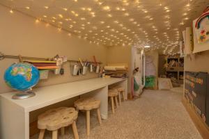 a classroom with a desk with stools and lights on the ceiling at Mountain Retreat in Frisco