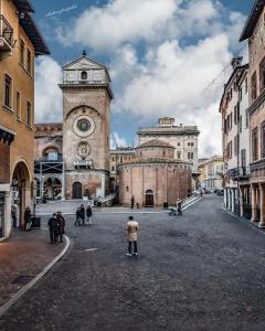 a group of people standing in front of a clock tower at CIVICO 14 Holiday Rooms in Suzzara
