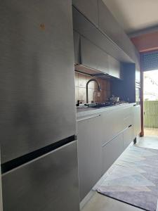 a kitchen with white cabinets and a sink at Casa GopNa in Udine
