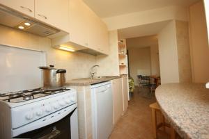 a kitchen with a stove and a counter top at Linda in Feriolo
