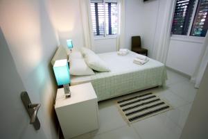 a small bedroom with a bed and a window at Pissouri Beach Apartments in Pissouri