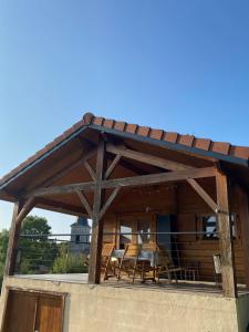 a pavilion with a table and chairs on a house at Chalet in Parois