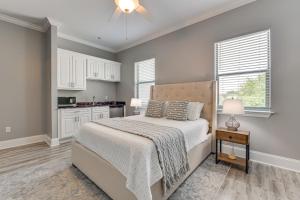a bedroom with a bed and a kitchen at Downtown Bay St Louis Condo - Walk to Beach! in Bay Saint Louis