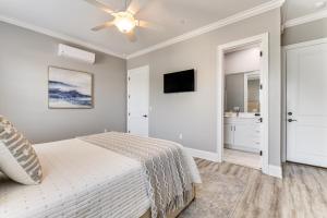 a bedroom with a bed and a ceiling fan at Downtown Bay St Louis Condo - Walk to Beach! in Bay Saint Louis