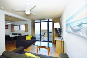 a living room with a couch and a table at Riverview Holiday Apartment 9 - Kalbarri WA in Kalbarri