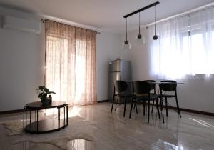 a dining room with a table and black chairs at Seaside Serenity "Earth" with pool, 150m from sea in Sukošan