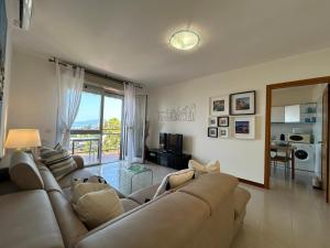 a living room with a couch and a table at Maison Panorama - Portofino View in Lavagna