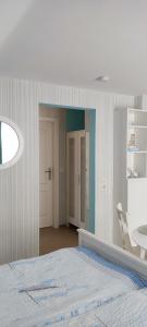 a bedroom with a bed and a table and a chair at Ferienwohnung Schmetterling II in Grossenbrode
