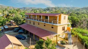 an overhead view of a house with a balcony at La Playa hostel in Mazunte