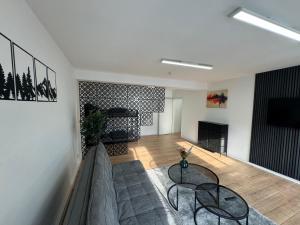 a living room with two tables and a couch at Apartment in zentraler Lage No 3 in Rostock