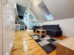 a living room with a couch and a table at Loft Osijek in Osijek