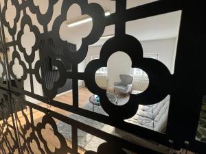 a view of a room through a gate with a chair at Apartment in zentraler Lage No 3 in Rostock