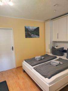 a bedroom with a bed with two towels on it at Apartment Waldkauz in Bad Lauterberg