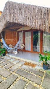 a room with a hammock in front of a house at 4 Elementos Guest House in Arraial d'Ajuda +19 photos