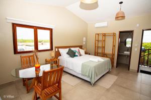 a bedroom with a bed and a glass table at Villaz Lençóis Maranhenses in Santo Amaro +95 photos