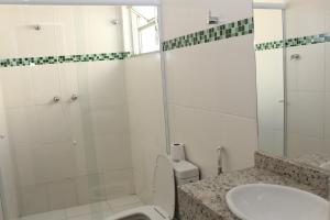 a bathroom with a shower and a toilet and a sink at Espigão Palace Hotel in Resende +19 photos