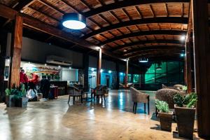 a lobby with chairs and tables in a building at Rainforest Hotel & Cabañas in Puerto Iguazú
