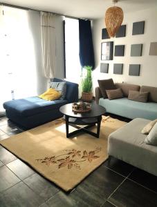 a living room with a couch and a table at Très Beau Logement en centre ville in Beaugency