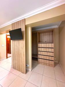 A television and/or entertainment centre at Hotel Andros