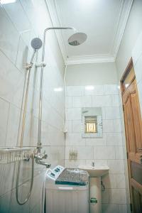 a bathroom with a shower and a sink at Joshean Apartments in Wakiso