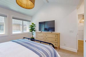 a bedroom with a bed and a dresser with a tv at Mickey's Hideaway in Anaheim