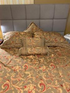 a bed with a blanket and pillows on it at Private Guest Bedroom-1W West Room - Close to Lake Michigan in Sheboygan