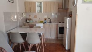 a small kitchen with a white table and chairs at NANA apartment in Ohrid
