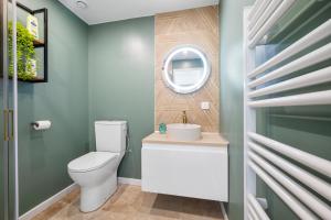 a bathroom with a toilet and a mirror at Cosy & Chill Appartements - Superbe vue mer, Wifi & Clim in Cagnes-sur-Mer