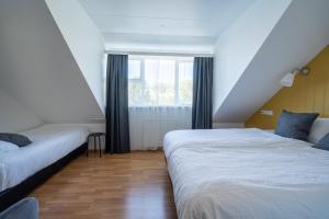 Postel nebo postele na pokoji v ubytování Hotel Breiddalsvik